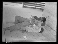 Migratory agricultural worker sleeping in grading station at Camden, North Carolina. Sourced from the Library of Congress.