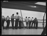 Migratory agricultural workers crossing from Norfolk to Cape Charles on the ferry. This group has just finished picking potatoes in North Carolina and is going to Onley, Virginia. Sourced from the Library of Congress.