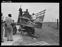 This truck carrying about thirty-seven North Carolina migrants to pick beans near Easton, Maryland broke down on the road near Princess Anne, Maryland. Sourced from the Library of Congress.