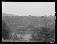 [Untitled photo, possibly related to: View of upper Mauch Chunk from East Mauch Chunk. In the background is Mount Pisgah and the second cut in the mountain from the right is the remains of the old switchback]. Sourced from the Library of Congress.