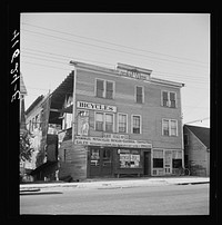 [Untitled photo, possibly related to: Old bicycle used as a sign for a repair shop in Thompsonville, Connecticut]. Sourced from the Library of Congress.