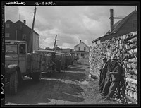 French-Canadian potato farmers waiting outside of a starch factory for their potatoes to be graded and weighed. Van Buren, Maine. See general caption Aroostook number 1. Sourced from the Library of Congress.
