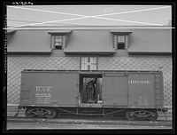 Loading potatoes into a freight car at the freight terminal of the Bangor and Aroostook Railroad in Caribou, Maine. Sourced from the Library of Congress.