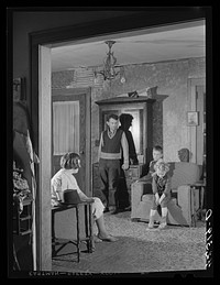 Mr. and Mrs. Edward L. Gay and their two children, dairy and poultry farmers of Groton, Connecticut. He has a twenty-three acre farm and was completely flooded out during the hurricane. Sourced from the Library of Congress.