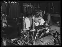 A sewing machine operator at "Levine & Levine" ladies coats who also runs a small farm near Colchester, Connecticut. Sourced from the Library of Congress.
