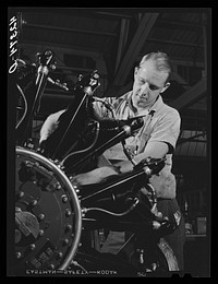 A workman on the final assembly of a Pratt and Whitney "WASP" engine. East Hartford, Connecticut. Sourced from the Library of Congress.