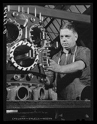 Working on the assembly of a Pratt and Whitney Engine. At the plant in East Hartford, Connecticut. Sourced from the Library of Congress.