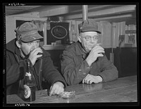 Shipyard workers stop in for a "beer" after work. In a bar just outside the Bath Iron Works. Bath, Maine. Sourced from the Library of Congress.