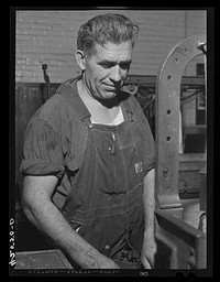 Loom-fixer at the Denomah Mills in Taftville, Connecticut, who also runs a small farm not far from town. Sourced from the Library of Congress.