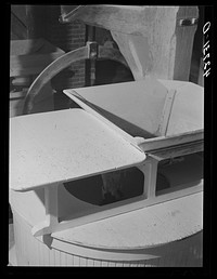 [Untitled photo, possibly related to: Corn over the grinding stone in Kenyon's johnnycake flour mill in Usquepaugh, Rhode Island]. Sourced from the Library of Congress.