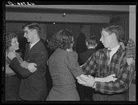 At a Saturday night square dance in Clayville, Rhode Island. Sourced from the Library of Congress.