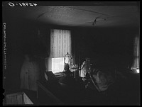 [Untitled photo, possibly related to: Woman in dilapidated old house in the Mount Washington district of Beaver Falls, Pennsylvania. She is blind in one eye and her other one is going bad too. She expressed the hope that she would lose her sight completely so she could get some money from blind pension]. Sourced from the Library of Congress.