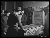 Playing the pinball machine at the steelworkers' Serbian Club in Aliquippa, Pennsylvania. Sourced from the Library of Congress.