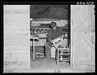 This man is a carpenter at Fort Bragg, North Carolina. This converted truck is his home. The interior of his truck was more roomy than most of the cabins that had been built at the camp where he was staying. At a settlement near Silver Lake, North Carolina (about ten miles out of Fayetteville, N.C.). Sourced from the Library of Congress.