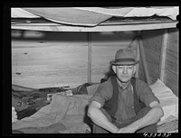 Four men live in this small shack. Two sleep on the lower cot and two on the upper. The whole shack is made so that it can be loaded onto a truck, has no floor all. At present the men work at Fort Bragg, North Carolina. Near Fayetteville, North Carolina. Sourced from the Library of Congress.