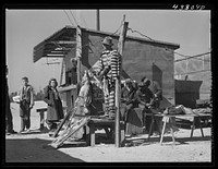 [Untitled photo, possibly related to: A traveling side-show. "Crime Museum," consisting of a dilapidated effigies of famous criminals run by an old, shellshocked World War veteran. Near Silver Lake, North Carolina]. Sourced from the Library of Congress.