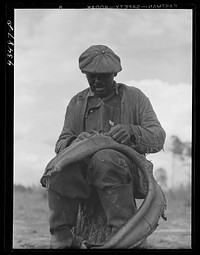 Repairing a mule harness on a farm near Moncks Corner, South Carolina. Sourced from the Library of Congress.