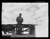 [Untitled photo, possibly related to: Rebuilding a house carried out of the Santee-Cooper Basin near Moncks Corner, South Carolina]. Sourced from the Library of Congress.