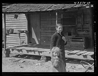 Children of a "squatter" family who were preparing to move out of the Spartanburg Army camp area. Near Whitestone, South Carolina. Sourced from the Library of Congress.