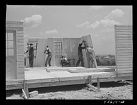 Getting up the walls on a prefabricated house being built by FSA (Farm Security Administration) to house some of the farmers when they move out of the Spartanburg Army camp area. Pacolet, South Carolina region. Sourced from the Library of Congress.