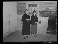[Untitled photo, possibly related to: Mrs. Harvey and a neighbor watching her belongings being moved out of her house in the Camp Croft area near Whitestone, South Carolina]. Sourced from the Library of Congress.