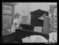 Mrs. L. A. Anderson, helping a neighbor move out of Camp Croft area.  Near Whitestone, South Carolina. Sourced from the Library of Congress.