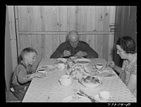 [Untitled photo, possibly related to: Family having lunch at their new prefabricated house at Pacolet, South Carolina]. Sourced from the Library of Congress.