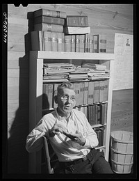 [Untitled photo, possibly related to: Mr. J. H. Parham, barber and notary public, in his shop in Centralhatchee, Heard County, Georgia]. Sourced from the Library of Congress.