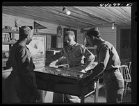 [Untitled photo, possibly related to: Soldiers from Fort Benning in a country store near Phenix City, Alabama]. Sourced from the Library of Congress.