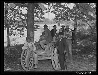 Waiting for FSA (Farm Security Administration) meeting of  borrowers to begin. Near Woodville, Greene County, Georgia. Sourced from the Library of Congress.