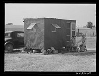 Mrs. David Gurly Tull, her son, and husband came from Arkansas looking for work at the new powder plant near Childersburg. Mr. Tull couldn't get a job at the powder plant but found temporary employment building bunkhouses. Childersburg, Alabama. Sourced from the Library of Congress.