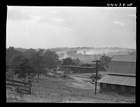 Landscape near one of the entrances to the powder plant near Childersburg. The dust in the back ground in caused by a great stream of traffic coming out of the powder plant. Alabama. Sourced from the Library of Congress.