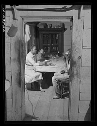 [Untitled photo, possibly related to: Ward and his wife looking at sterioptican pictures. FSA (Farm Security Administration) borrower in Greene County, Georgia]. Sourced from the Library of Congress.