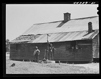 [Untitled photo, possibly related to: Children of Mr. Frank Cahnipian at their FSA (Farm Security Administration) pump. White Plains, Greene County, Georgia]. Sourced from the Library of Congress.