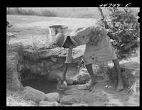 Getting water out of a spring on a farm in northern Greene County, Georgia. Sourced from the Library of Congress.