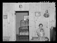 This woman and her family moved from the Army maneuver ground area to a prefabricated house built by FSA (Farm Security Administration) to take care of some of these families. Milford, Caroline County, Virginia. Sourced from the Library of Congress.