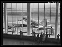 An airliner on the field seen through the window of the waiting room. Municipal airport, Washington, D.C.. Sourced from the Library of Congress.