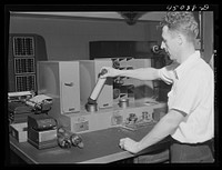 Sending the weather data down thru the compressed air tube from the teletype room. Washington, D.C. municipal airport. Sourced from the Library of Congress.
