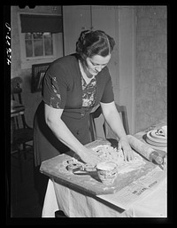 [Untitled photo, possibly related to: Mrs. W. Gaynor preparing dinner on their farm near Fairfield, Vermont]. Sourced from the Library of Congress.