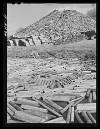 [Untitled photo, possibly related to: Wood pile outside the Mississquoi Corporation paper mill in Seldon Springs, Vermont]. Sourced from the Library of Congress.