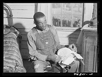 Penfield, Greene County, Georgia (vicinity). Illiterate FSA (Farm Security Administration) client who keeps his government letters neatly strung on a wire. Sourced from the Library of Congress.