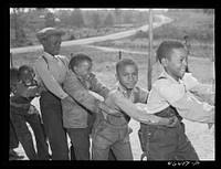 Boyd Jones, playing tug-of-war with class mates during play period at the Alexander Community School in Greene County, Georgia. Sourced from the Library of Congress.