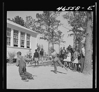 Boyd Jones playing dodge ball during recess at the Alexander Community School, Greene County, Georgia. Sourced from the Library of Congress.
