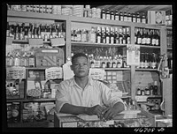 Bayamon, Puerto Rico (vicinity). Proprietor of a small general store, which will soon be evacuated because it is in an area to be taken over by the Army. Sourced from the Library of Congress.