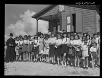 Corozal, Puerto Rico (vicinity). The priest, the glee club and others who attended the tenant purchase celebration on a farm. Sourced from the Library of Congress.