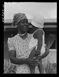 [Untitled photo, possibly related to: Frederiksted (vicinity), Saint Croix Island, Virgin Islands. FSA (Farm Security Administration) borrower and his family who live in one of the homestead houses]. Sourced from the Library of Congress.