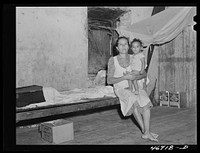 [Untitled photo, possibly related to: Saint Croix Island, Virgin Islands. Puerto Rican woman and her children, FSA (Farm Security Administration) borrower, living in the slum village of "Barren Spot"]. Sourced from the Library of Congress.