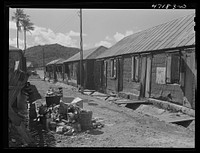 Charlotte Amalie, Saint Thomas Island, Virgin Islands. A group of long row houses near the water front. Sourced from the Library of Congress.