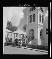 [Untitled photo, possibly related to: Christiansted, Saint Croix Island, Virgin Islands. Coming out of church on a Sunday]. Sourced from the Library of Congress.