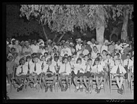 [Untitled photo, possibly related to: Charlotte Amalie, Saint Thomas Island, Virgin Islands. Choir singing Christmas carols at the Red Cross meeting held in the square]. Sourced from the Library of Congress.